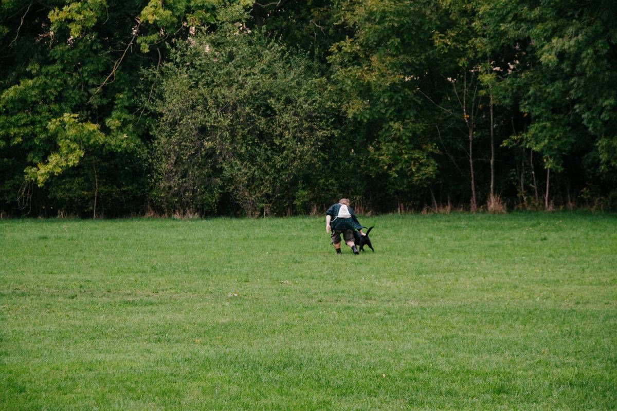 Trainer giving a treat to a happy rescue dog after completing a task.