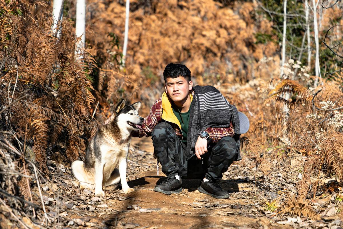 A handler guiding a rescue dog through obstacle courses as part of training for a search team.